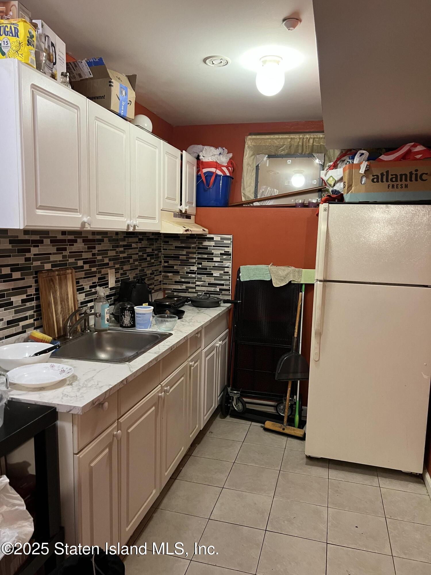 256 Maple Parkway Staten Island, NY 10303 - Photo 18 of 21 a kitchen with stainless steel appliances granite countertop a sink and a stove