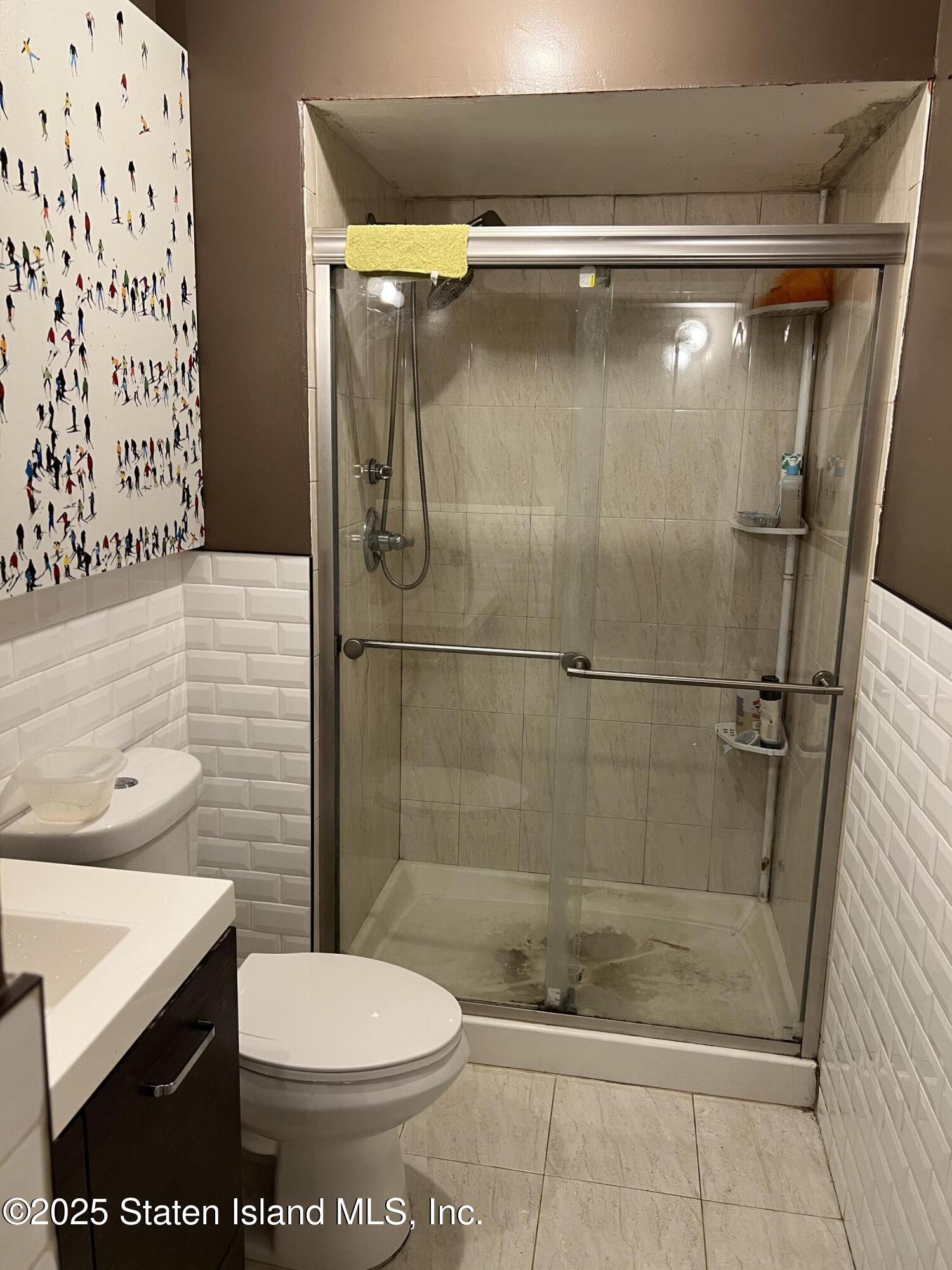 256 Maple Parkway Staten Island, NY 10303 - Photo 19 of 21 a bathroom with a shower and a toilet