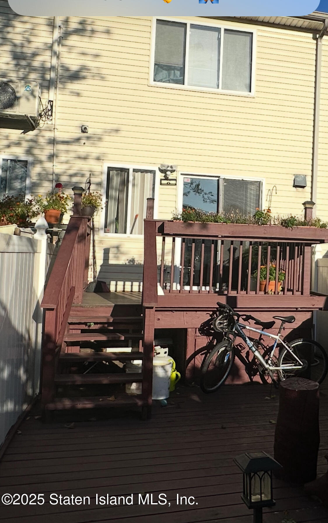 256 Maple Parkway Staten Island, NY 10303 - Photo 4 of 21 a view of a patio with table and chairs with wooden floor