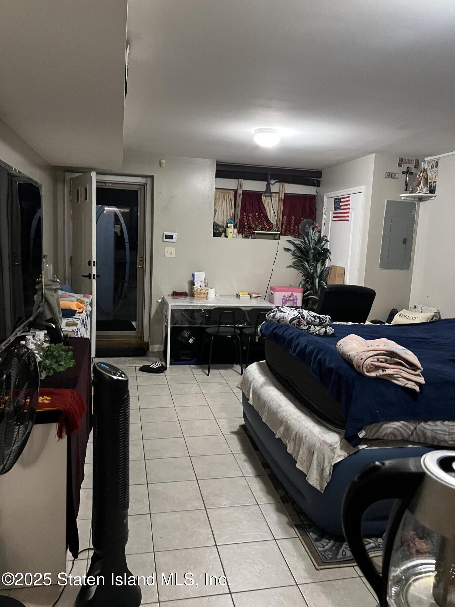 256 Maple Parkway Staten Island, NY 10303 - Photo 10 of 21 a living room with furniture and a flat screen tv