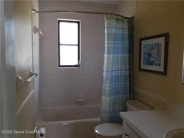 a bathroom with a toilet and shower