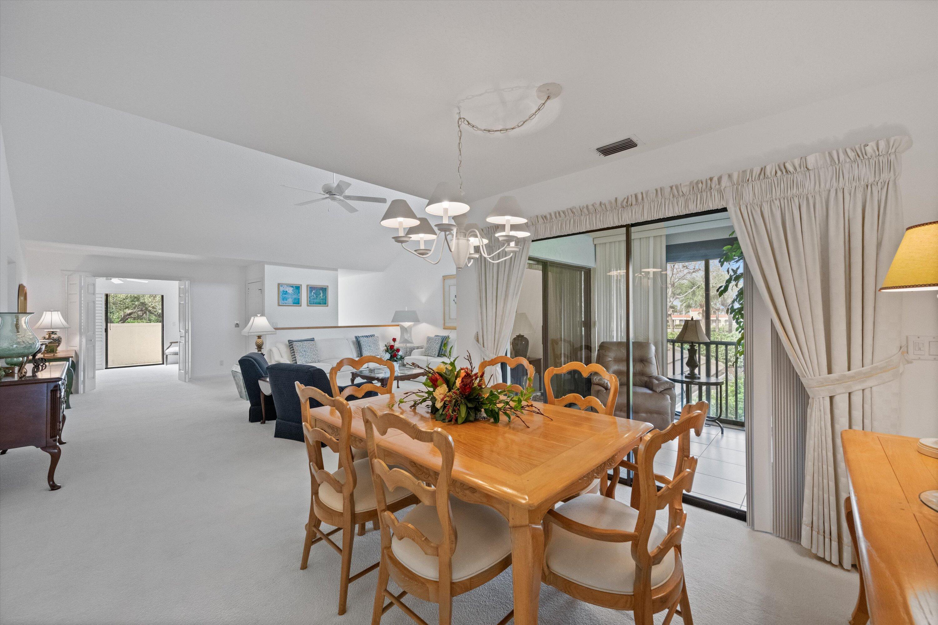 3971 Schooner Pointe Drive, Unit 201 Jupiter, FL 33477 - Photo 13 of 44 a dining room with furniture and window