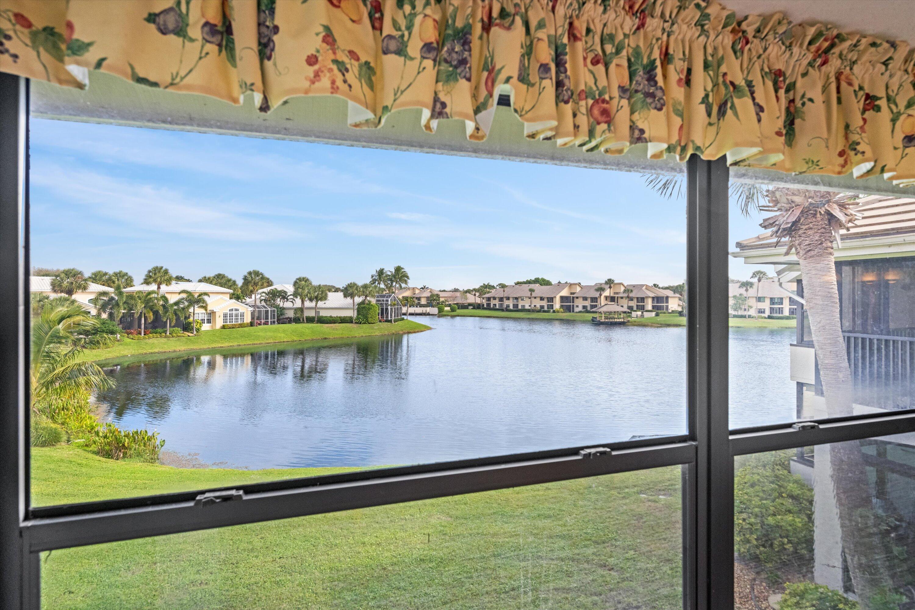 3971 Schooner Pointe Drive, Unit 201 Jupiter, FL 33477 - Photo 18 of 44 a view of a lake from a balcony