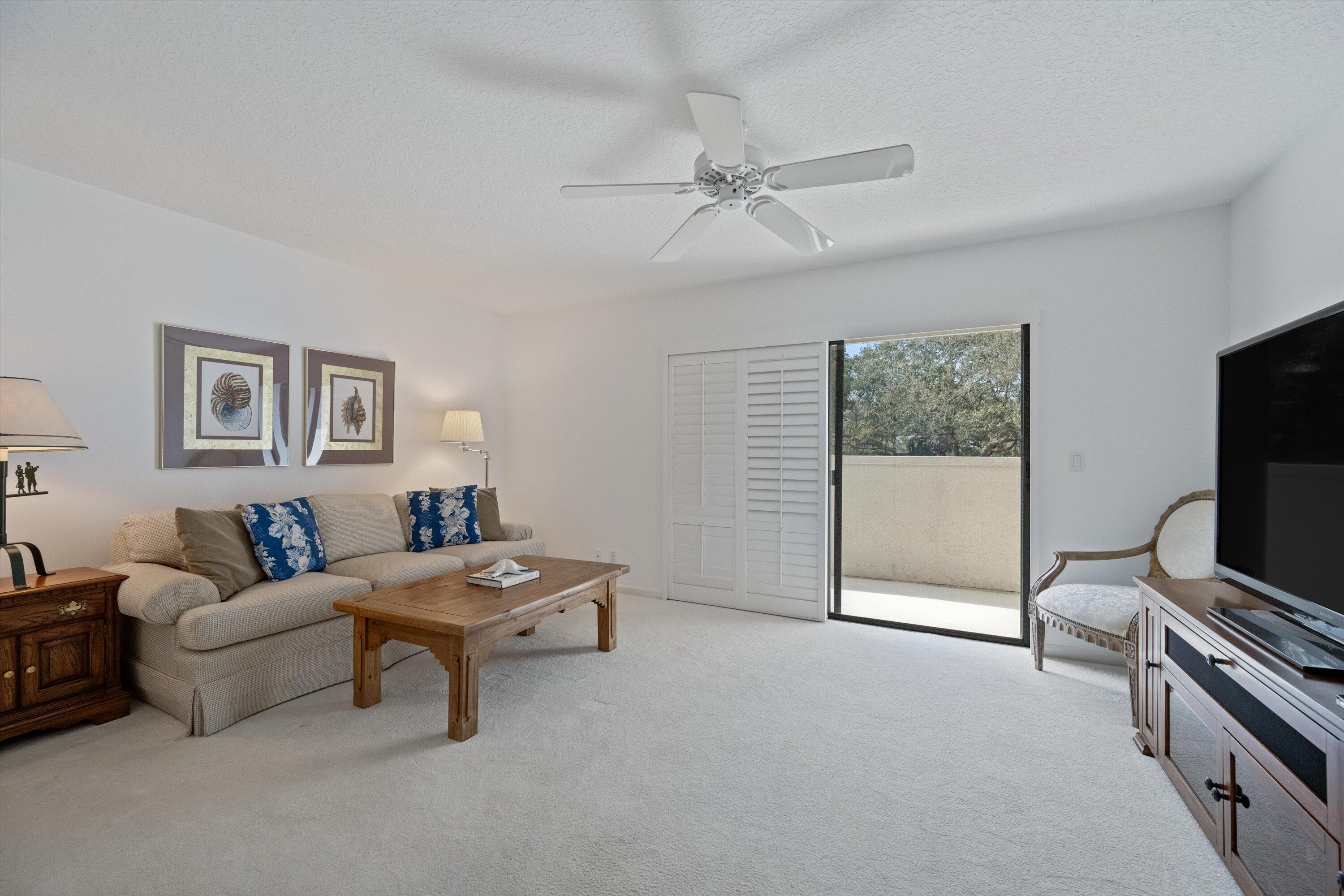 3971 Schooner Pointe Drive, Unit 201 Jupiter, FL 33477 - Photo 19 of 44 a living room with furniture and a flat screen tv