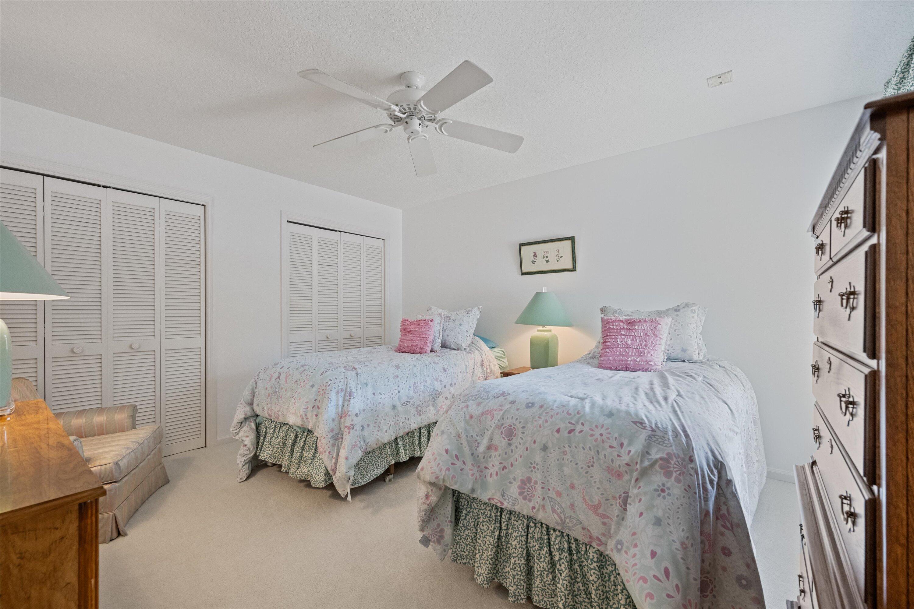 3971 Schooner Pointe Drive, Unit 201 Jupiter, FL 33477 - Photo 21 of 44 a bedroom with two beds and painted walls