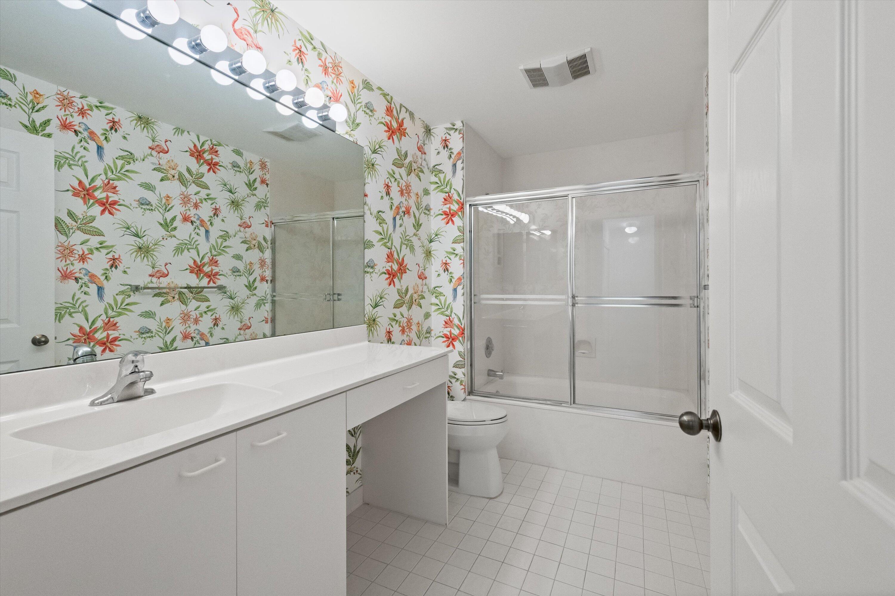 3971 Schooner Pointe Drive, Unit 201 Jupiter, FL 33477 - Photo 23 of 44 a bathroom with a sink toilet and shower