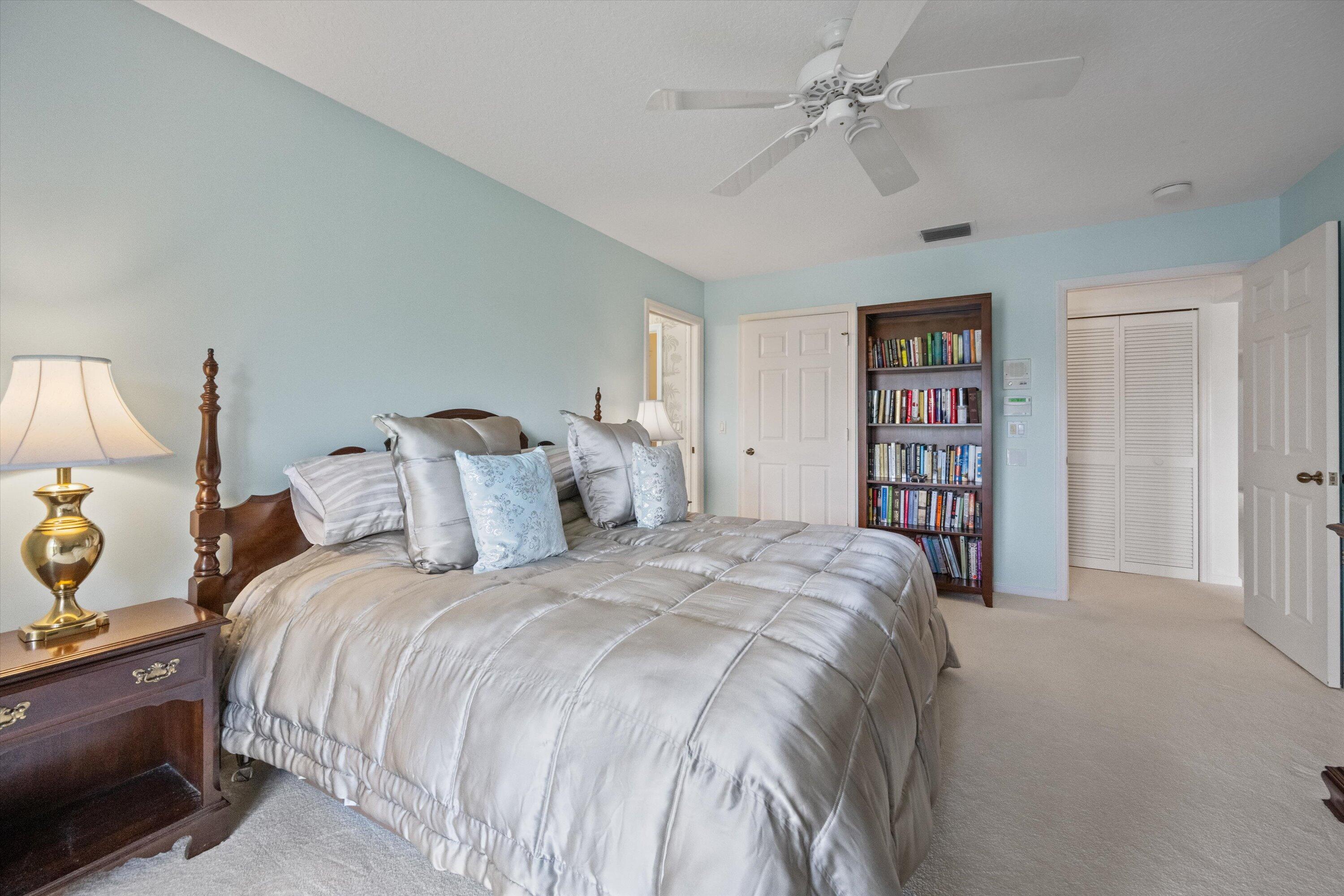 3971 Schooner Pointe Drive, Unit 201 Jupiter, FL 33477 - Photo 27 of 44 a bedroom with bed and a chandelier