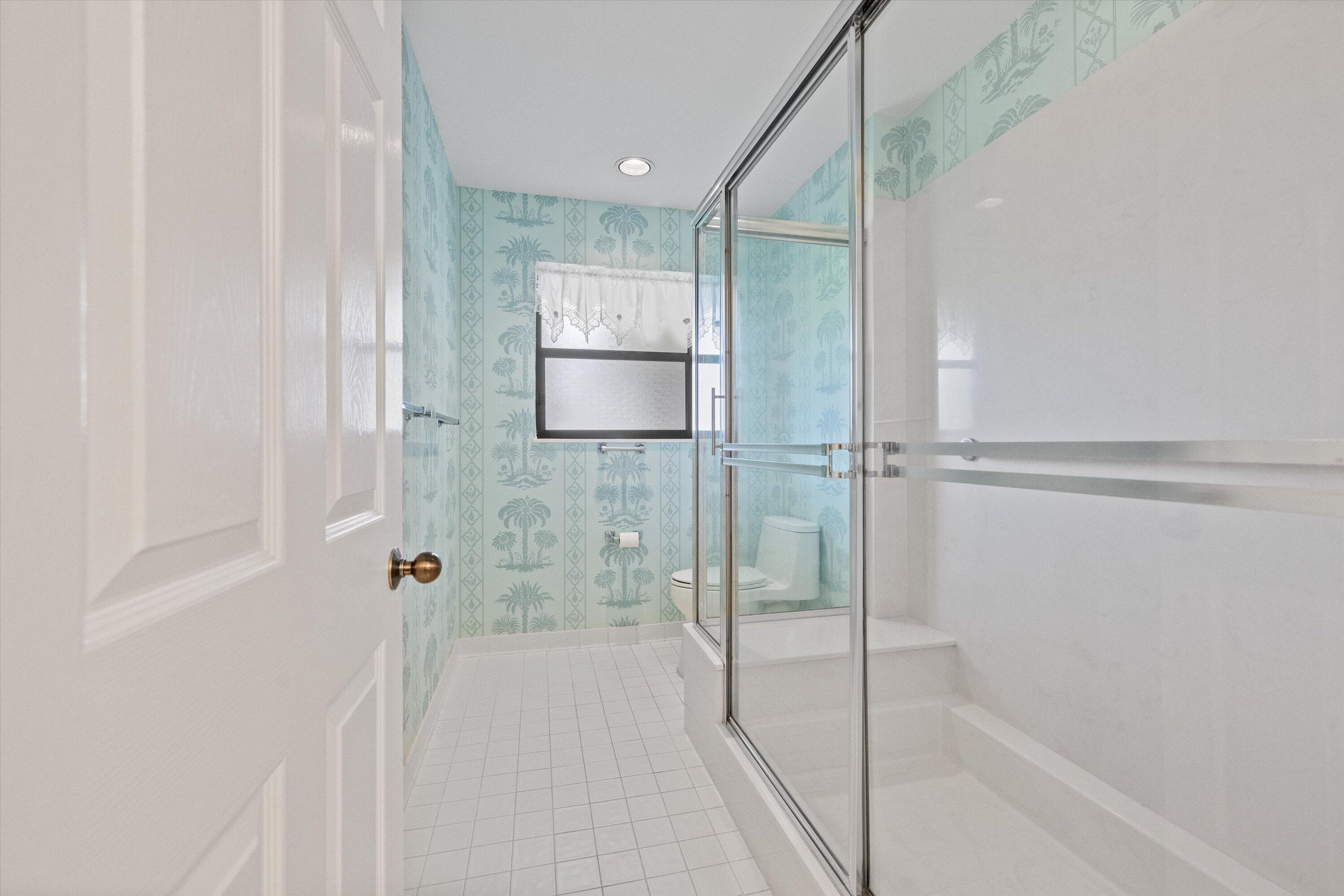 3971 Schooner Pointe Drive, Unit 201 Jupiter, FL 33477 - Photo 30 of 44 a bathroom with a shower and a bath tub