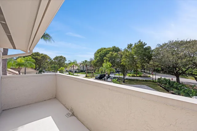 a view of outdoor space with deck and a lake view