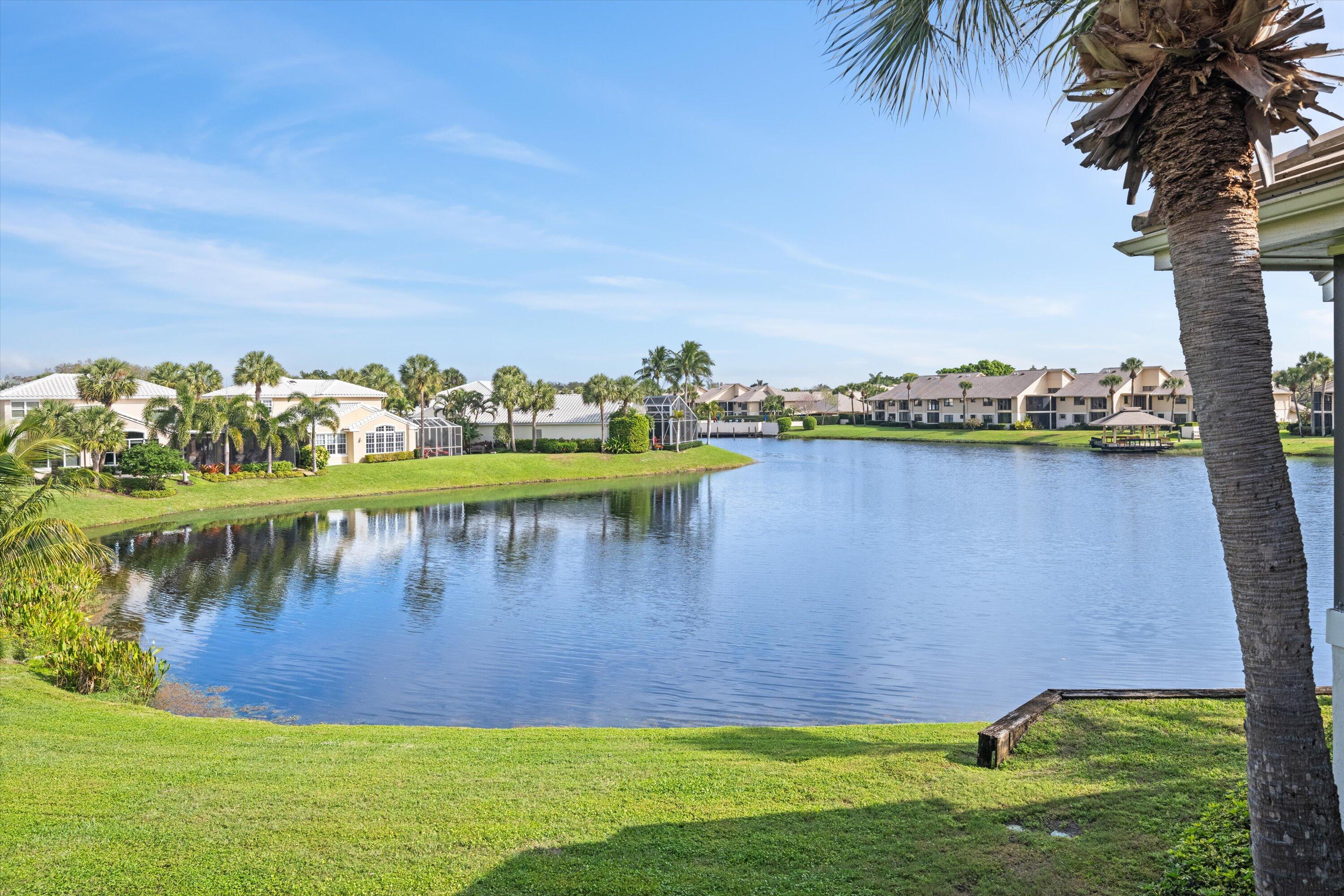 3971 Schooner Pointe Drive, Unit 201 Jupiter, FL 33477 - Photo 36 of 44 a view of a lake with houses