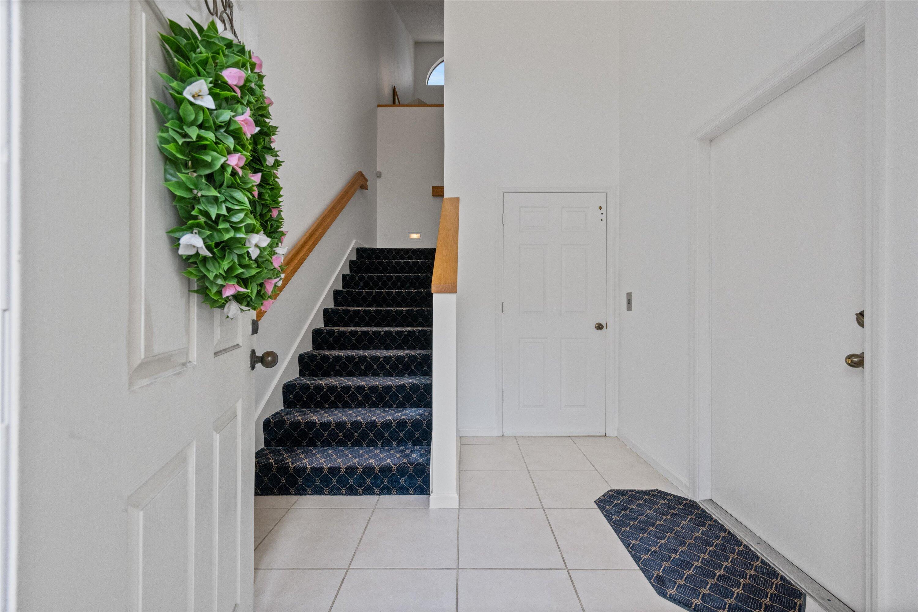 3971 Schooner Pointe Drive, Unit 201 Jupiter, FL 33477 - Photo 4 of 44 a view of entryway with stairs and wooden floor
