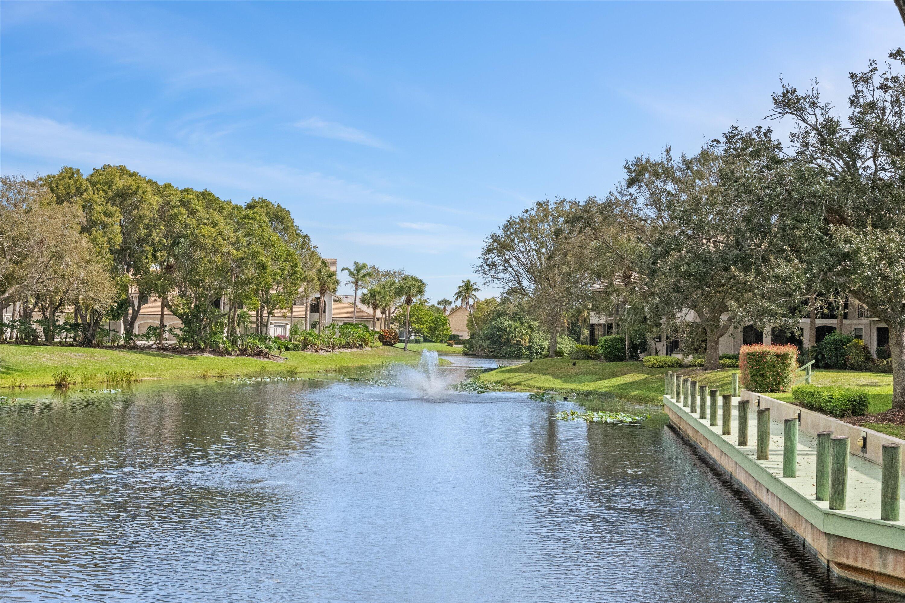 3971 Schooner Pointe Drive, Unit 201 Jupiter, FL 33477 - Photo 41 of 44 a view of a lake with a mountain