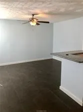 a view of a room with wooden floor