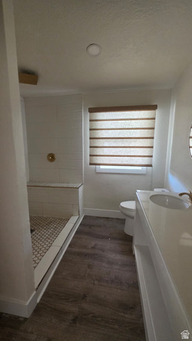 1450 North Dixie Downs Road, Unit 51 St. George, UT 84770 - Photo 18 of 25 Contemporary bathroom featuring a walk-in shower with a built-in bench, hexagon floor tiling, and a brass-finish shower fixture