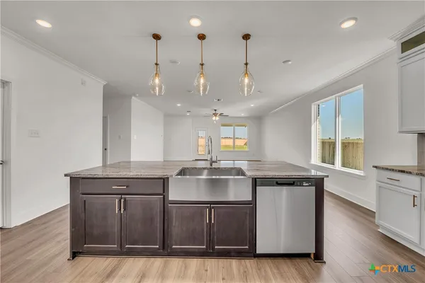 a kitchen with a stove and a wooden floors