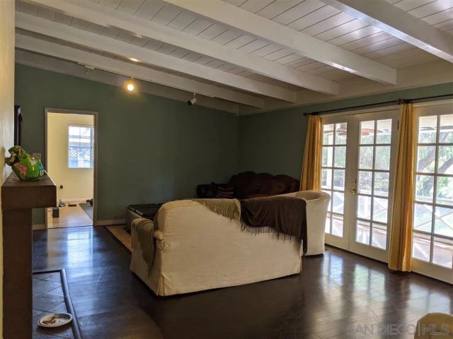 a bedroom with bed and wooden floor