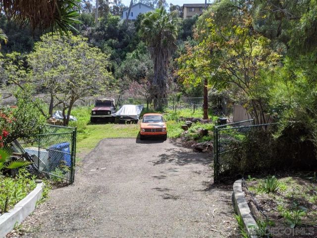 a backyard of a house with a yard and outdoor seating