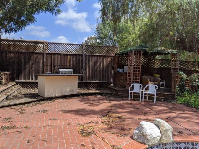 a view of a backyard with sitting area