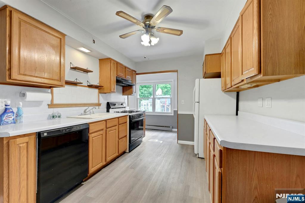 17 Butler Place Wanaque, NJ 07420 - Photo 16 of 28 a kitchen with a sink stainless steel appliances and cabinets