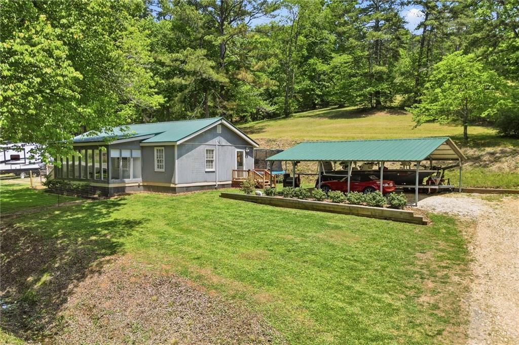 1709 Harrington Road Ball Ground, GA 30107 - Photo 29 of 46 a view of a house with a yard porch and sitting area