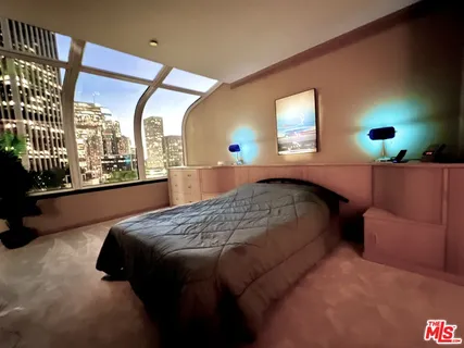 a bed sitting in a bedroom next to a window