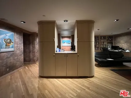 a view of a refrigerator in kitchen and wooden floor