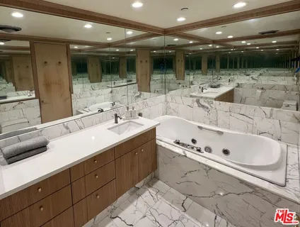 a spacious bathroom with a double vanity sink and a large mirror