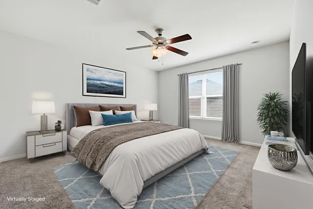 a bedroom with a bed and painting on the wall