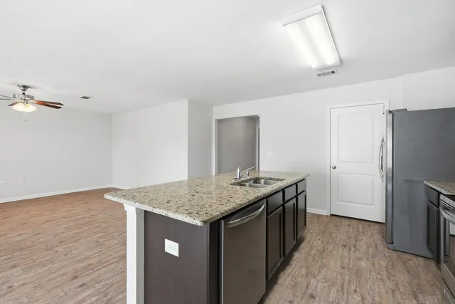 a view of a livingroom with furniture cabinets and wooden floor