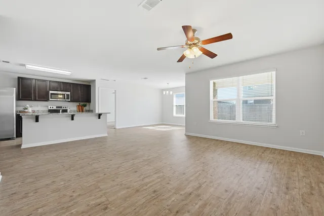 a kitchen with a refrigerator and cabinets