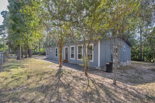 a backyard of a house with barbeque oven table and chairs