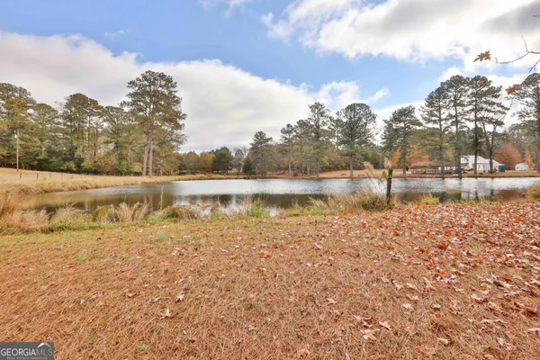 a view of a lake with houses in the background