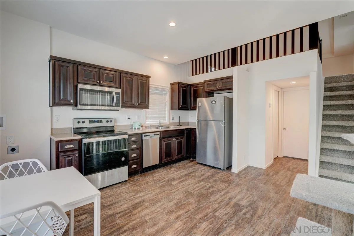 7495 Oakland Road, Unit 32 La Mesa, CA 91942 - Photo 1 of 16 a kitchen with stainless steel appliances granite countertop a refrigerator stove and oven