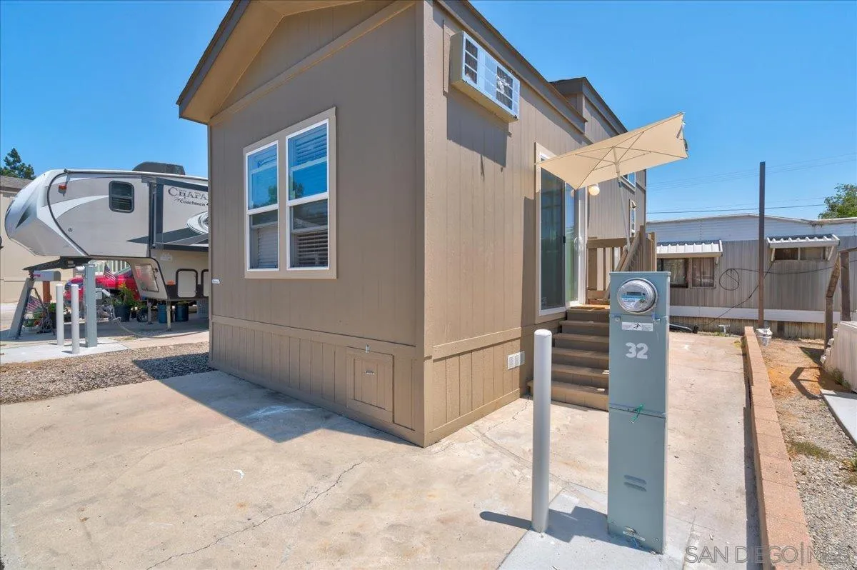 7495 Oakland Road, Unit 32 La Mesa, CA 91942 - Photo 11 of 16 a view of a patio with dining table and chairs with wooden floor