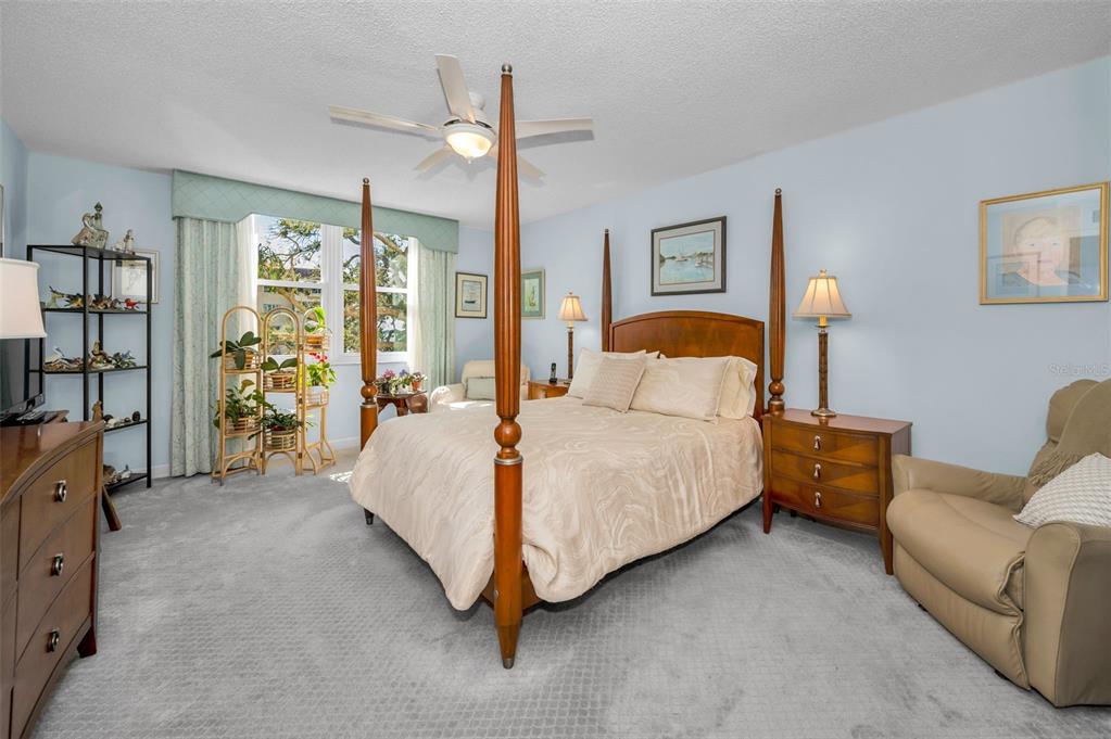 632 Edgewater Drive, Unit 433 Dunedin, FL 34698 - Photo 24 of 42 a spacious bedroom with a bed couch and a window