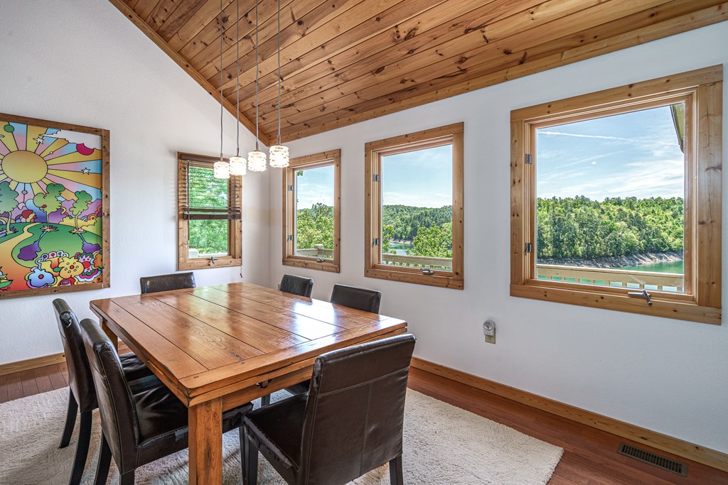 509 Lonesome Pine Road Murphy, NC 28906 - Photo 13 of 70 a view of a dining room with furniture a chandelier and wooden floor