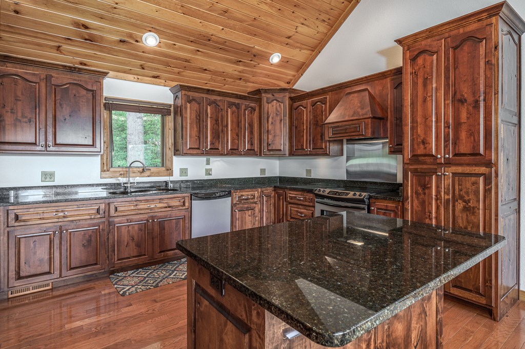 509 Lonesome Pine Road Murphy, NC 28906 - Photo 14 of 70 a kitchen with kitchen island granite countertop a sink a counter top space appliances and cabinets