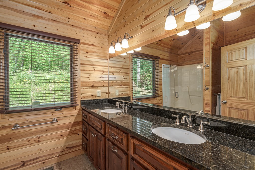 509 Lonesome Pine Road Murphy, NC 28906 - Photo 23 of 70 a bathroom with a granite countertop sink and a large mirror