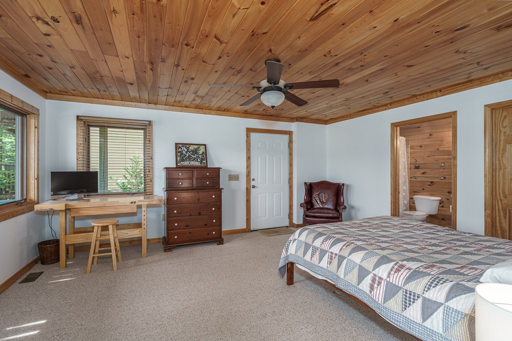 509 Lonesome Pine Road Murphy, NC 28906 - Photo 35 of 70 a bedroom with a bed and a chandelier