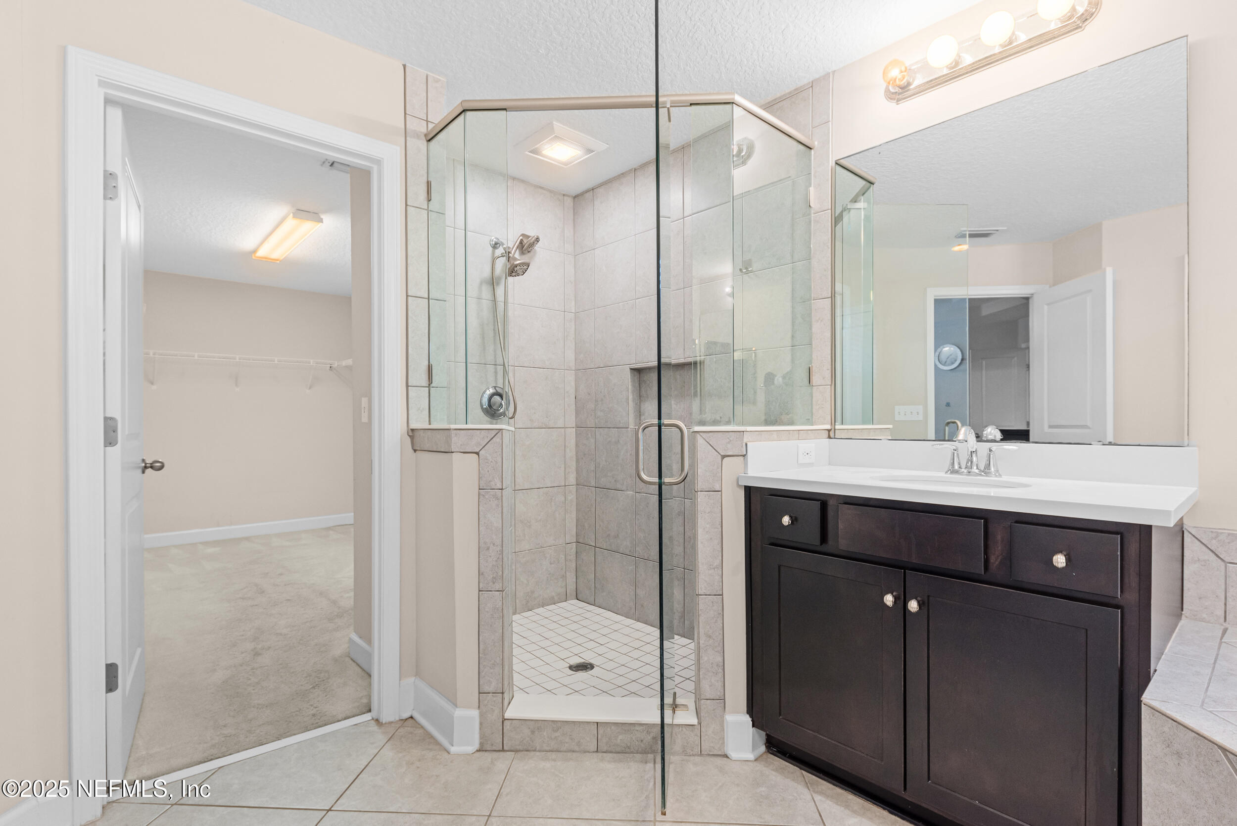 15672 Tisons Bluff Road Jacksonville, FL 32218 - Photo 20 of 42 a bathroom with a shower sink and mirror