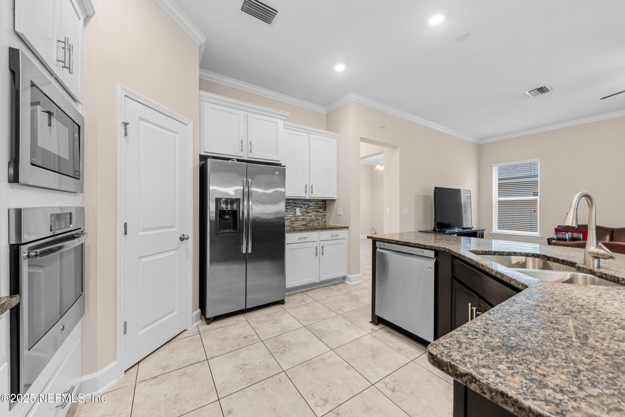 15672 Tisons Bluff Road Jacksonville, FL 32218 - Photo 28 of 42 a kitchen with stainless steel appliances granite countertop a refrigerator sink and stove