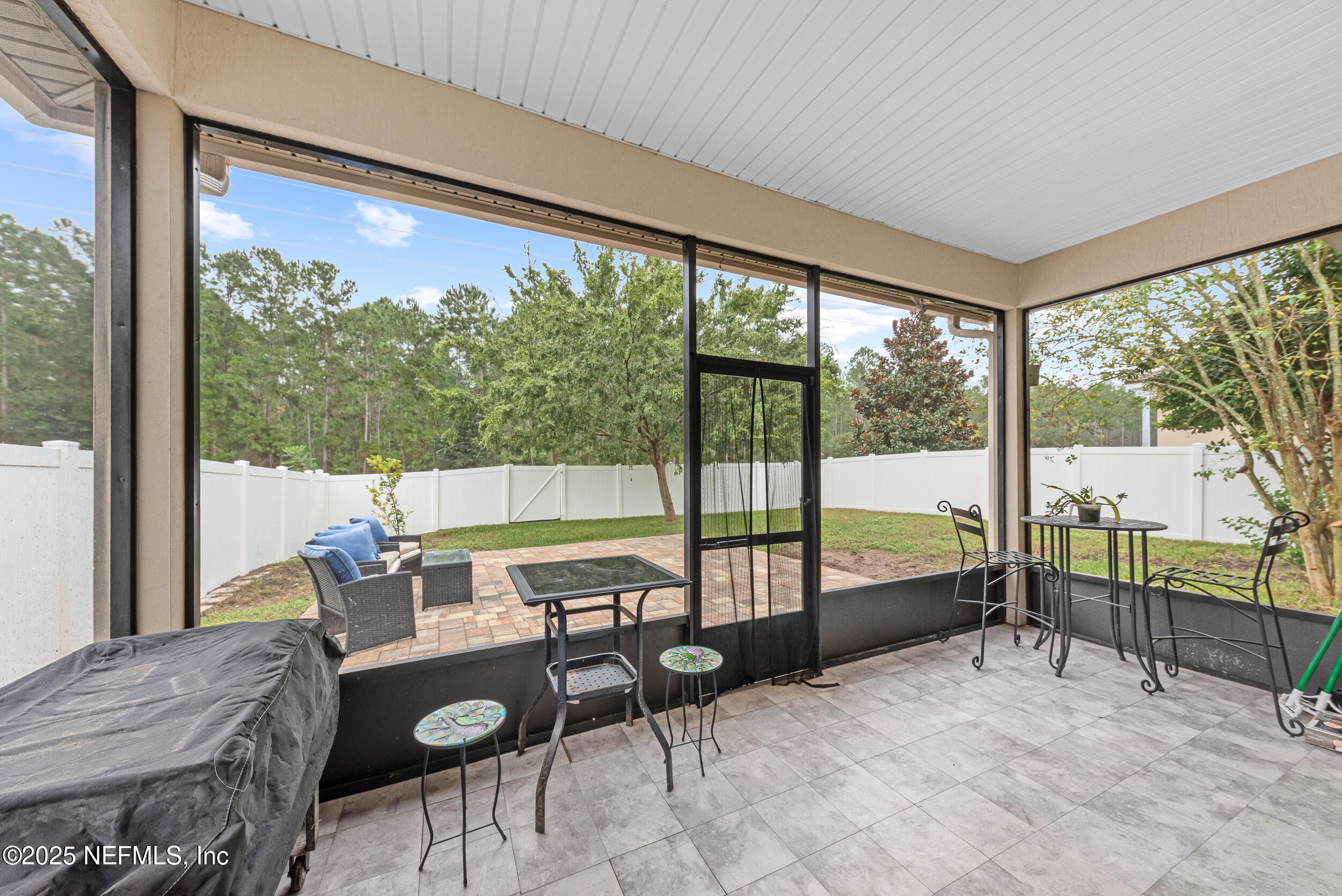15672 Tisons Bluff Road Jacksonville, FL 32218 - Photo 29 of 42 a living room with furniture and a floor to ceiling window