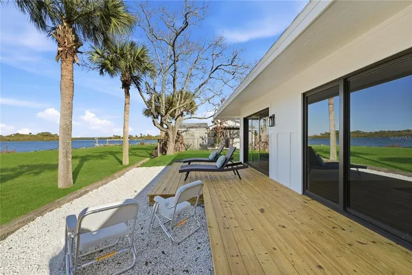 a view of a house with backyard porch and sitting area