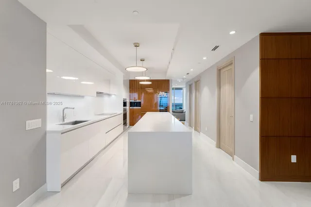 a view of a kitchen and refrigerator