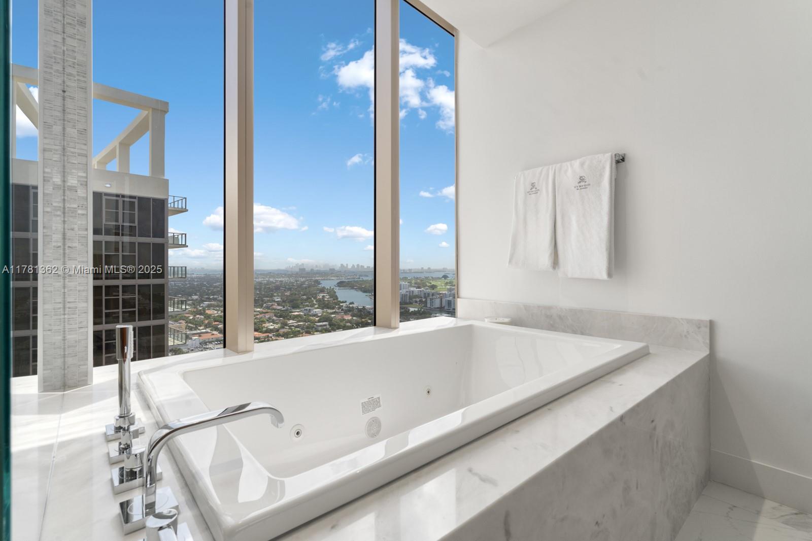 9705 Collins Avenue, Unit 2604N Bal Harbour, FL 33154 - Photo 18 of 42 a bath tub sitting next to a window