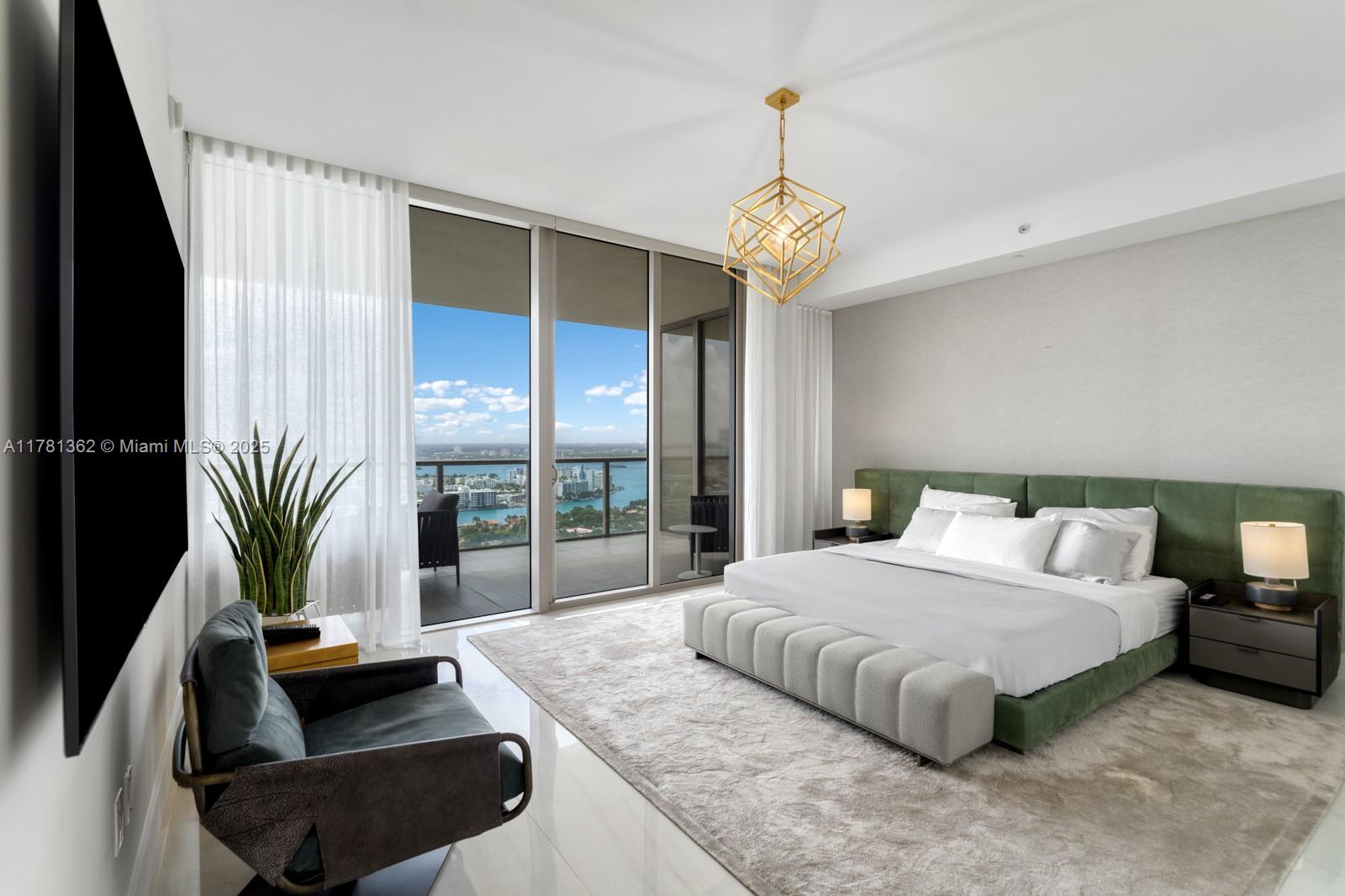 9705 Collins Avenue, Unit 2604N Bal Harbour, FL 33154 - Photo 21 of 42 a bedroom with a large bed and a chandelier