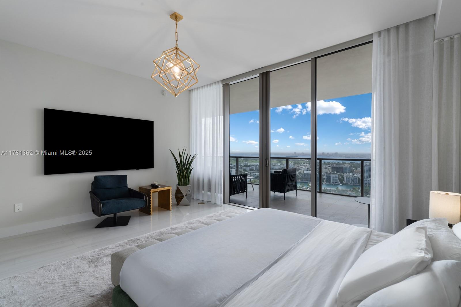 9705 Collins Avenue, Unit 2604N Bal Harbour, FL 33154 - Photo 22 of 42 a bedroom with a bed and a flat screen tv