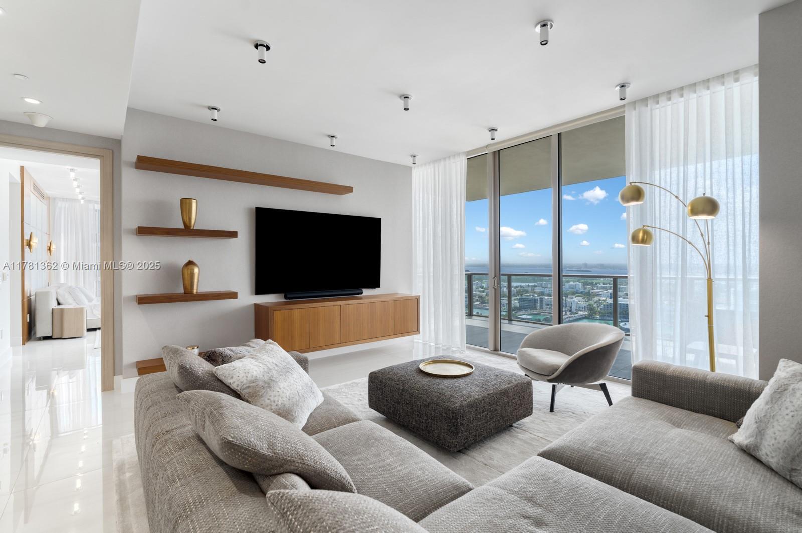 9705 Collins Avenue, Unit 2604N Bal Harbour, FL 33154 - Photo 26 of 42 a living room with furniture and a flat screen tv