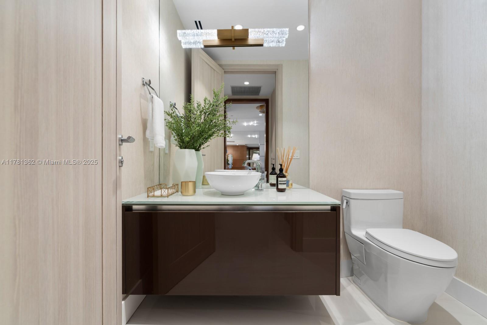 9705 Collins Avenue, Unit 2604N Bal Harbour, FL 33154 - Photo 31 of 42 a bathroom with a toilet a sink and mirror