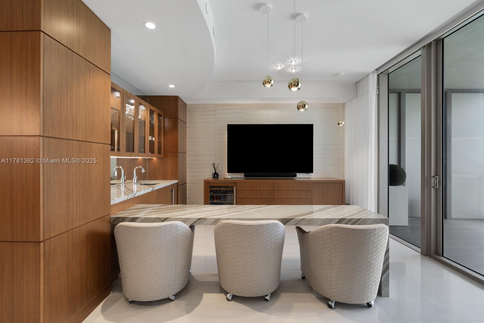 9705 Collins Avenue, Unit 2604N Bal Harbour, FL 33154 - Photo 7 of 42 a living room with furniture and a flat screen tv